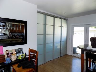 2-track, 4-panel, top-hung Room Divider with a silver frame and white laminated glass